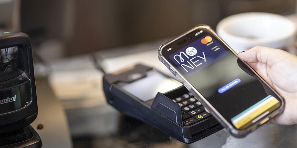 Someone paying using Apple Pay at a card reader