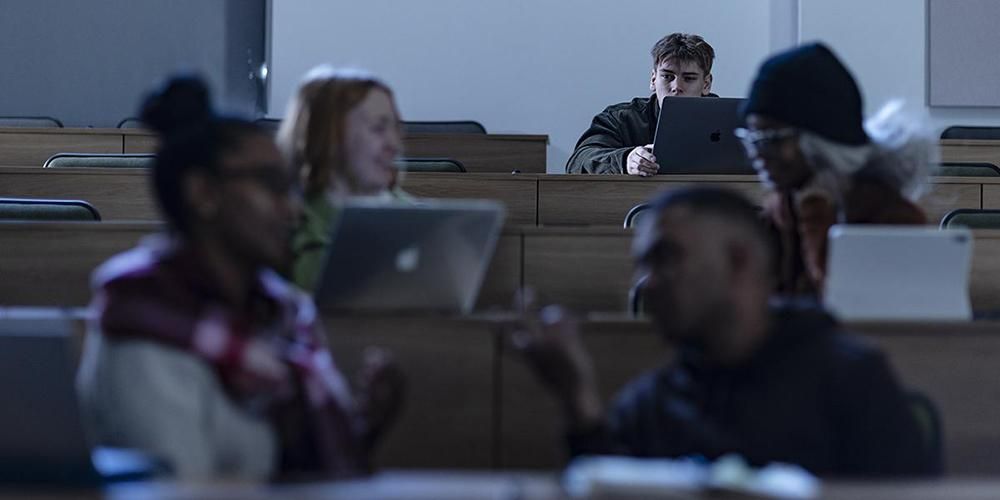People sitting in rows in a lecture theatre