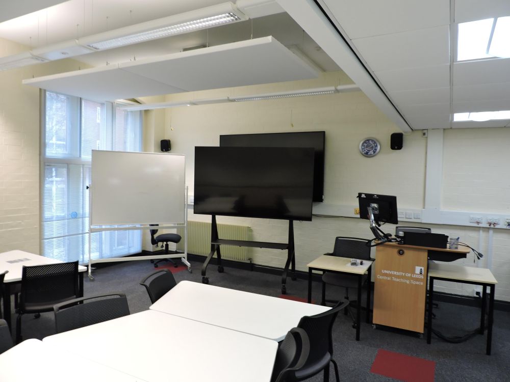 A room with a screen and lectern