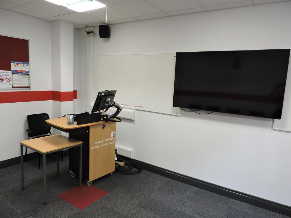 A room with a screen and lectern