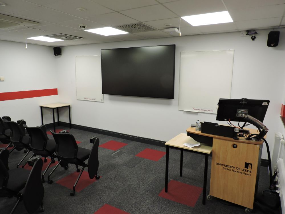 A room with a screen and lectern