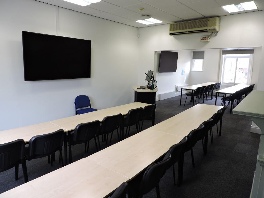 A room with tables and a screen