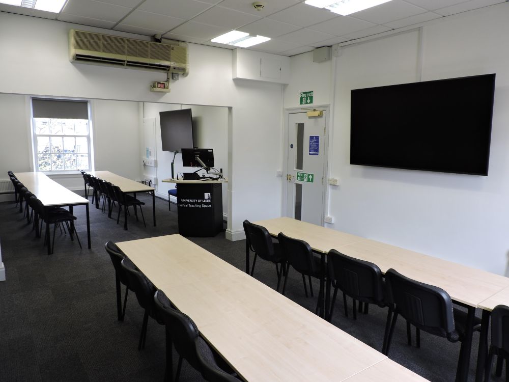 A room with tables and a screen