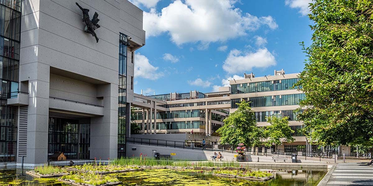 Roger Stevens building and pond on a sunny day.