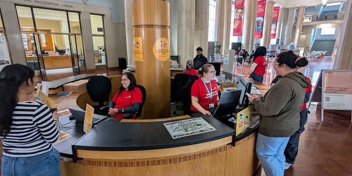 Staff members helping students at the Student Information Point in the Parkinson Building