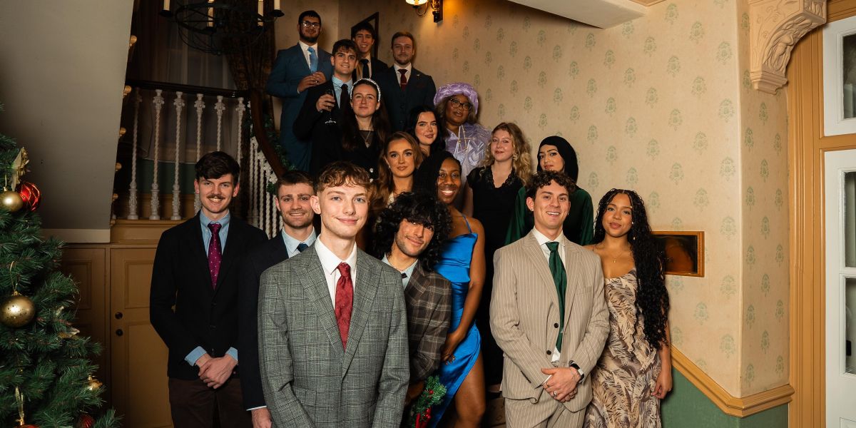 A group of scholars standing on a staircase