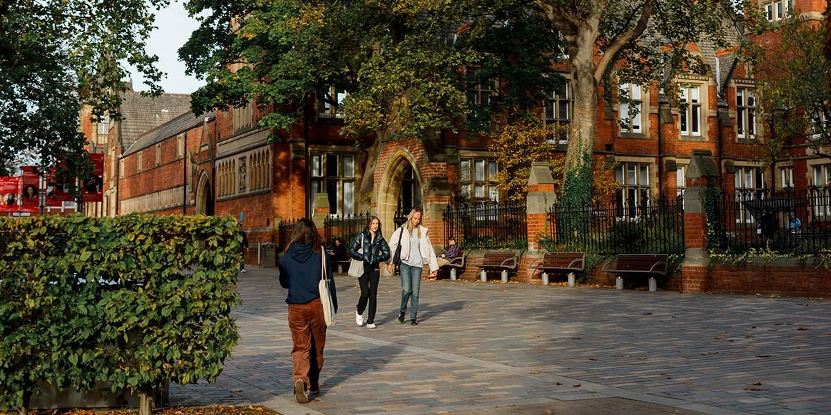 Students walking past clothworkers court in autumn