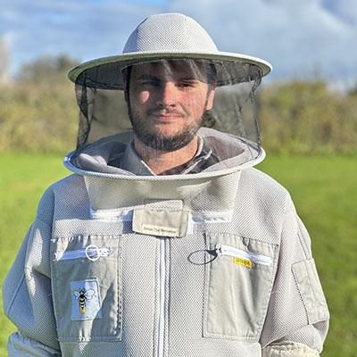 Enterprise Scholar Harry Simpson  wearing a bee keeping outfit