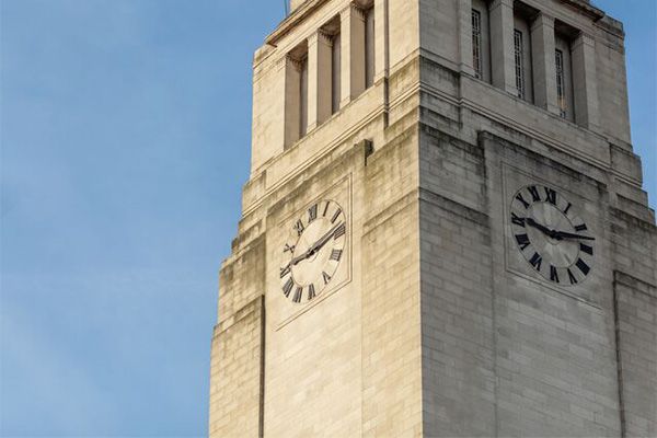 Exterior of the Parkinson Building clock tower with a clear blue sky.