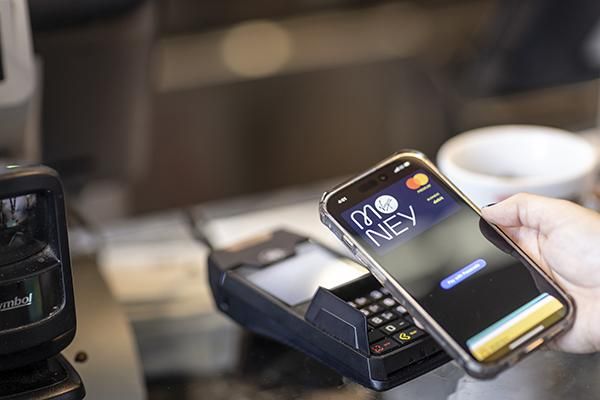 Someone paying using Apple Pay at a card reader