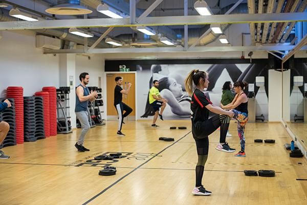 Students stretching in a fitness class at The Edge