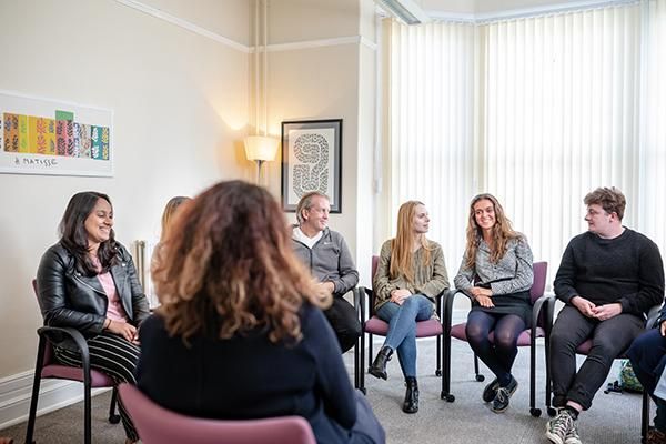 A group of students sitting in a wellbeing session