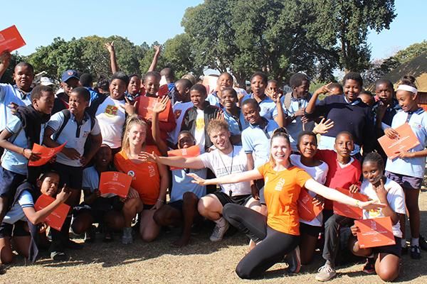 Students on the Gryphons Abroad volunteering programme pose with children in South Africa.