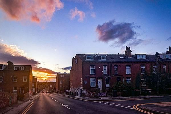 Buildings in Hyde park surrounded by pink clouds and a sunset