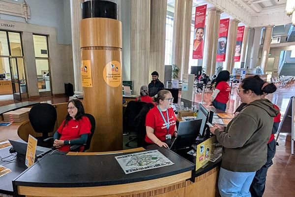 Staff members helping students at the Student Information Point in the Parkinson Building