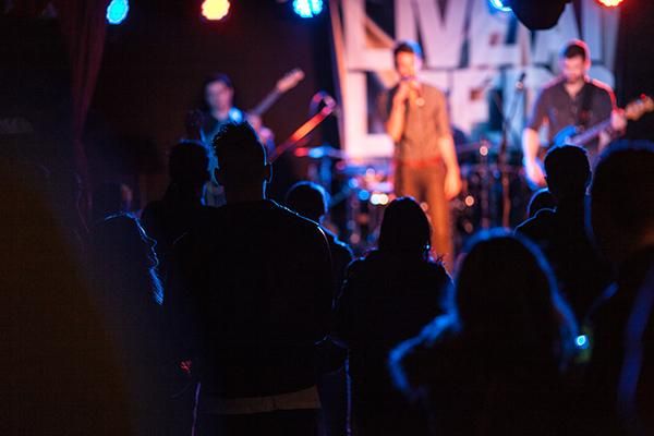 A band performing to a crowd at a Live at Leeds gig