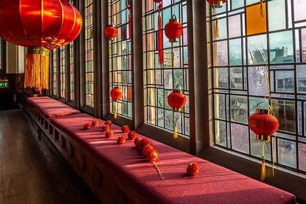 Red Spring Festival lanterns and decorations by a window on campus