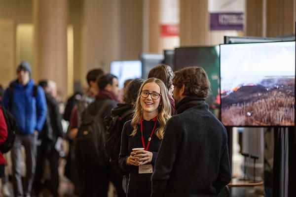 Student talking to a staff member at a postgraduate open day