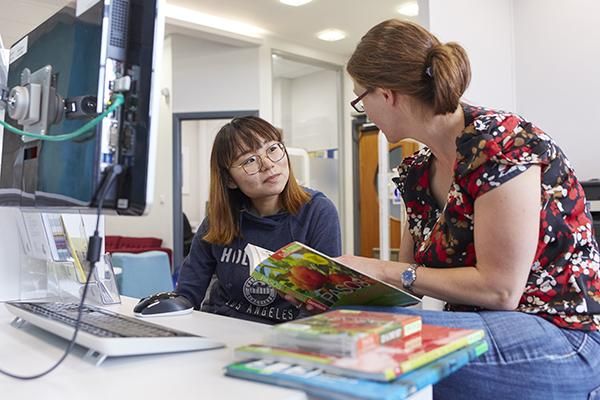 Pre-sessional student getting advice from a staff member in the Language Zone