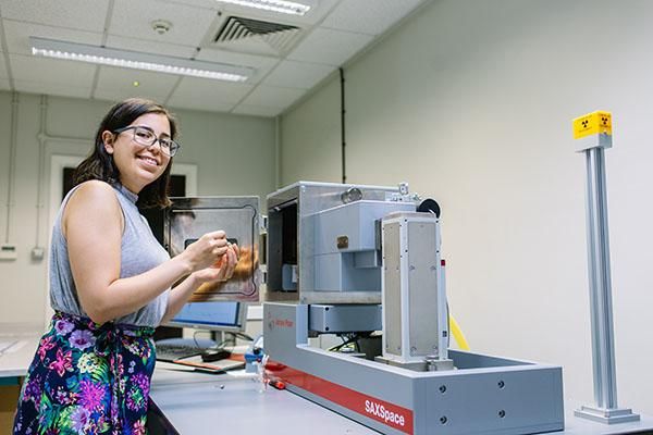 Student with machinery in a food colloids lab