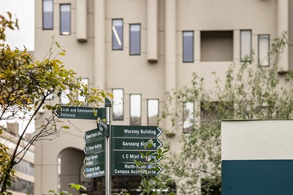 Signpost on campus pointing the way to various buildings