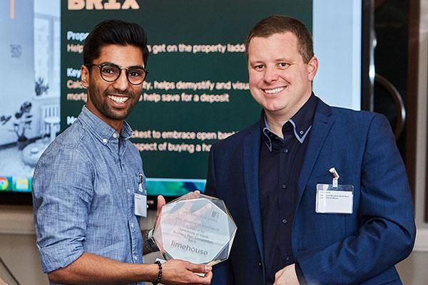 Spark business plan competition winner holding a trophy