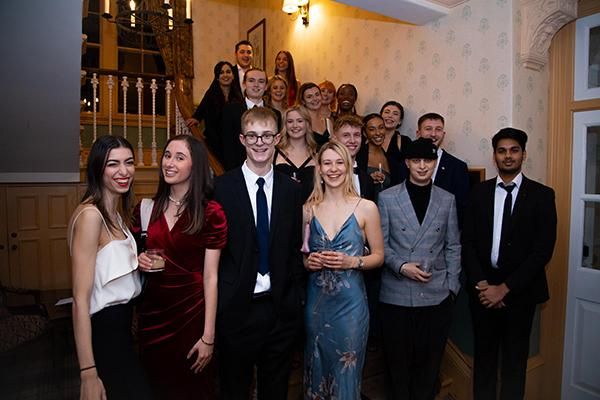 Spark enterprise scholars stand on a staircase at an event