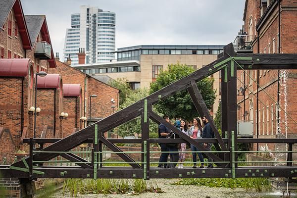 Students standing on a bridge near student accommodation in Leeds city centre