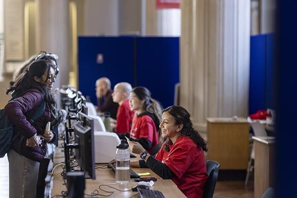 Staff member helping student at the Welcome Hub during Welcome Week