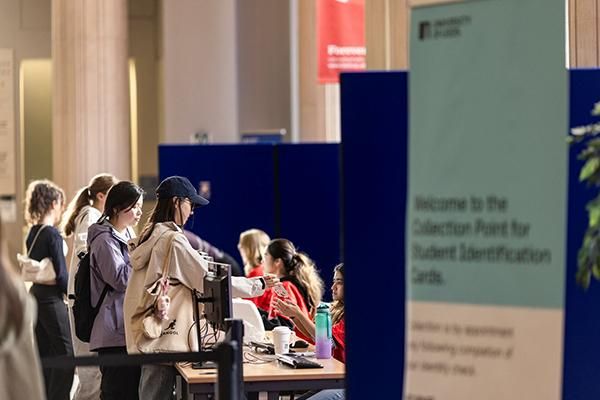 Students collecting student cards at a collection point