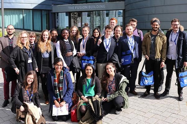 Students in a group outside a building at the British Conference of Undergraduate Research