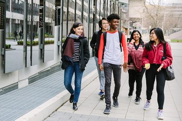 A group of students walking near the multi-storey car park in winter