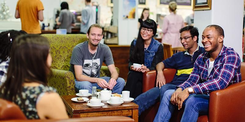 A group of students sitting and chatting at Global Cafe