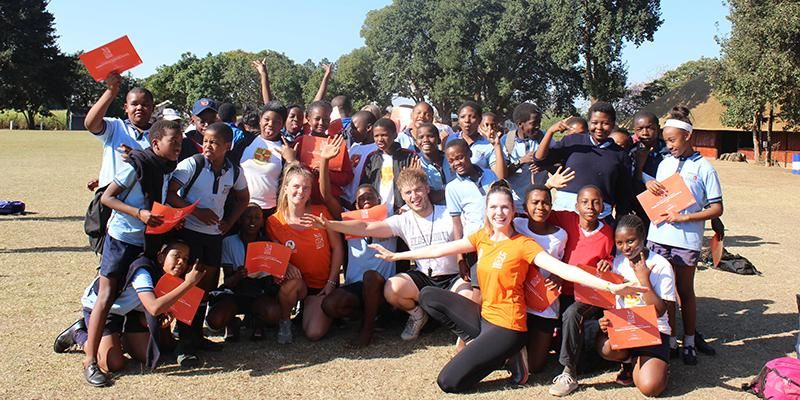 Students on the Gryphons Abroad volunteering programme pose with children in South Africa.