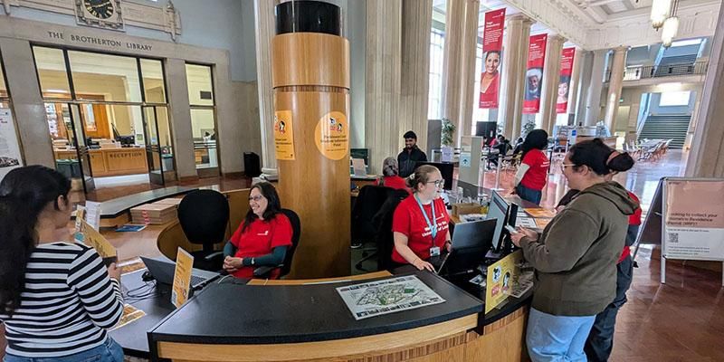 Staff members helping students at the Student Information Point in the Parkinson Building