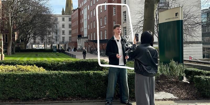 Student Content Creator filming another student on campus. A graphic of a phone screen surrounds one student.