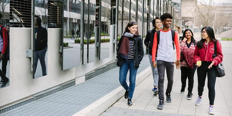 A group of students walking near the multi-storey car park in winter