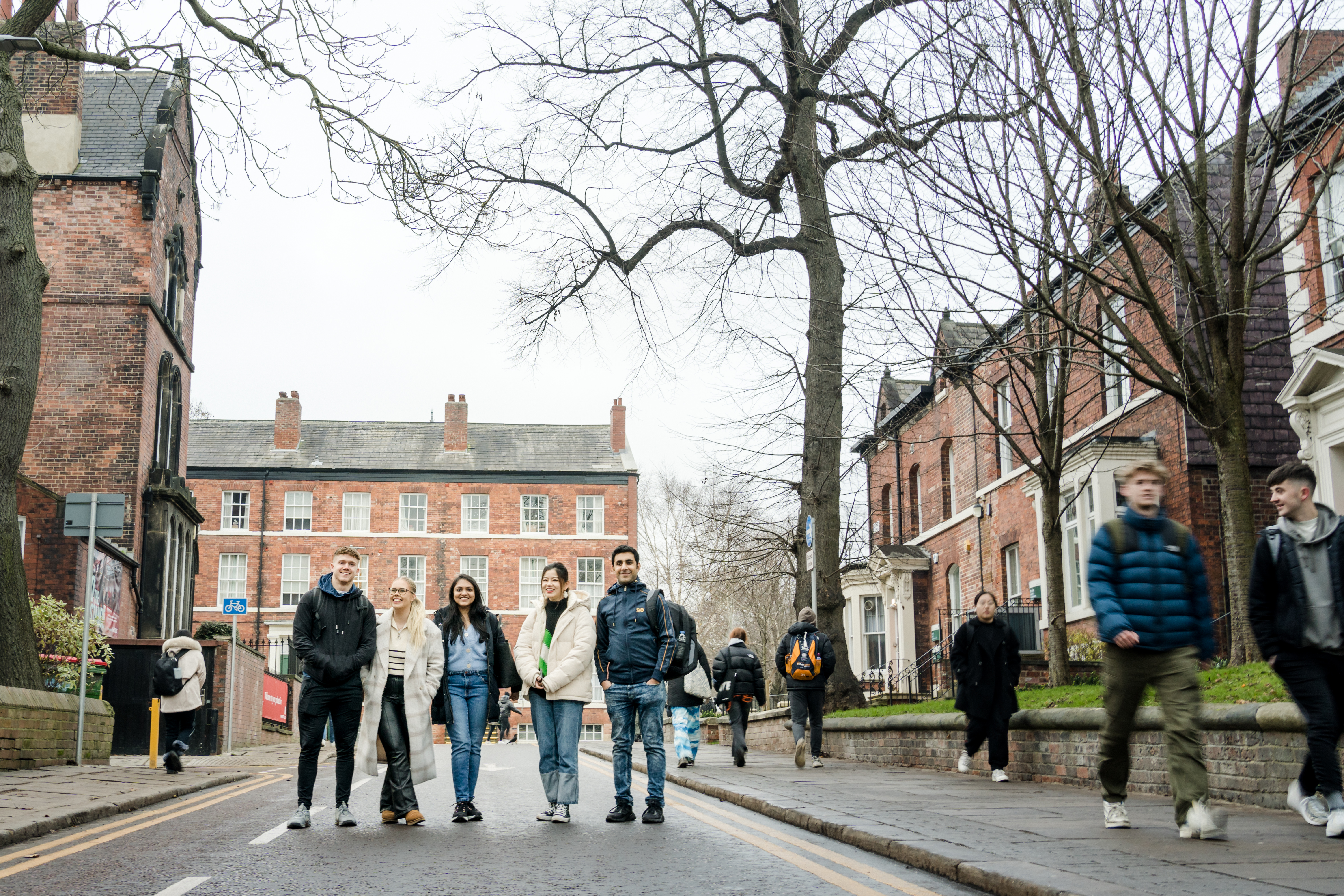 A group of students walking near the Business School. 