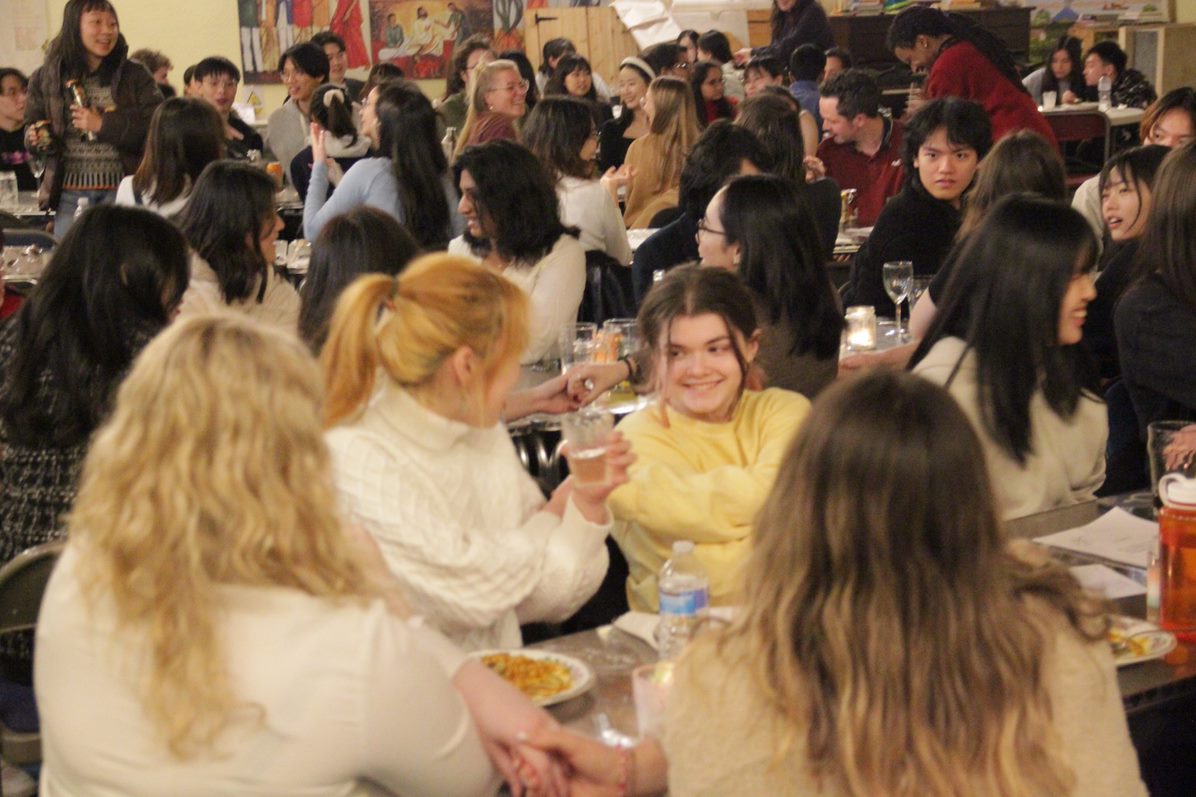 A large group of students having a meal.