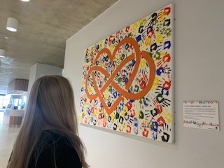 A female looking at a Unity canvas in the Laidlaw Library.